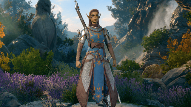 The Githyanki Warrior Lae'zel, with green skin, pointed ears, and heavy blue armor, stands before a serene forest background in BG3.